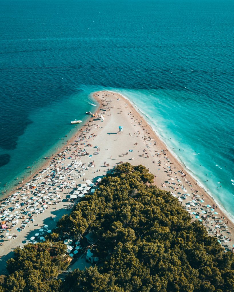 A stunning beach in Croatia, showcasing the pristine coastline and clear waters, perfect for an exclusive boat trip experience with Interblanc's luxury adventure travel services.