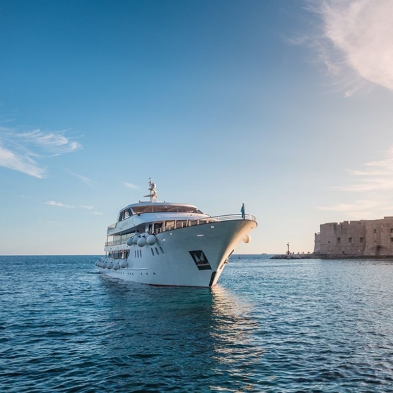 Luxury yacht cruising through clear blue waters, part of a 7-night luxury yacht cruise exploring Croatia's Adriatic Islands and historic cities, showcasing stunning seascapes and exclusive travel experiences