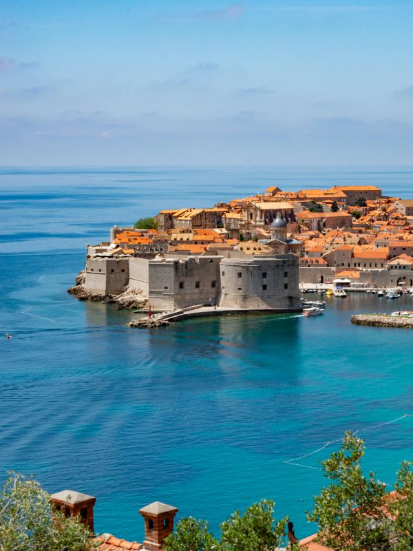 Luxury yacht anchored near Dubrovnik's historic cityscape, part of a 7-night luxury yacht cruise exploring Croatia's Adriatic Islands and historic cities, offering breathtaking views and unique experiences.